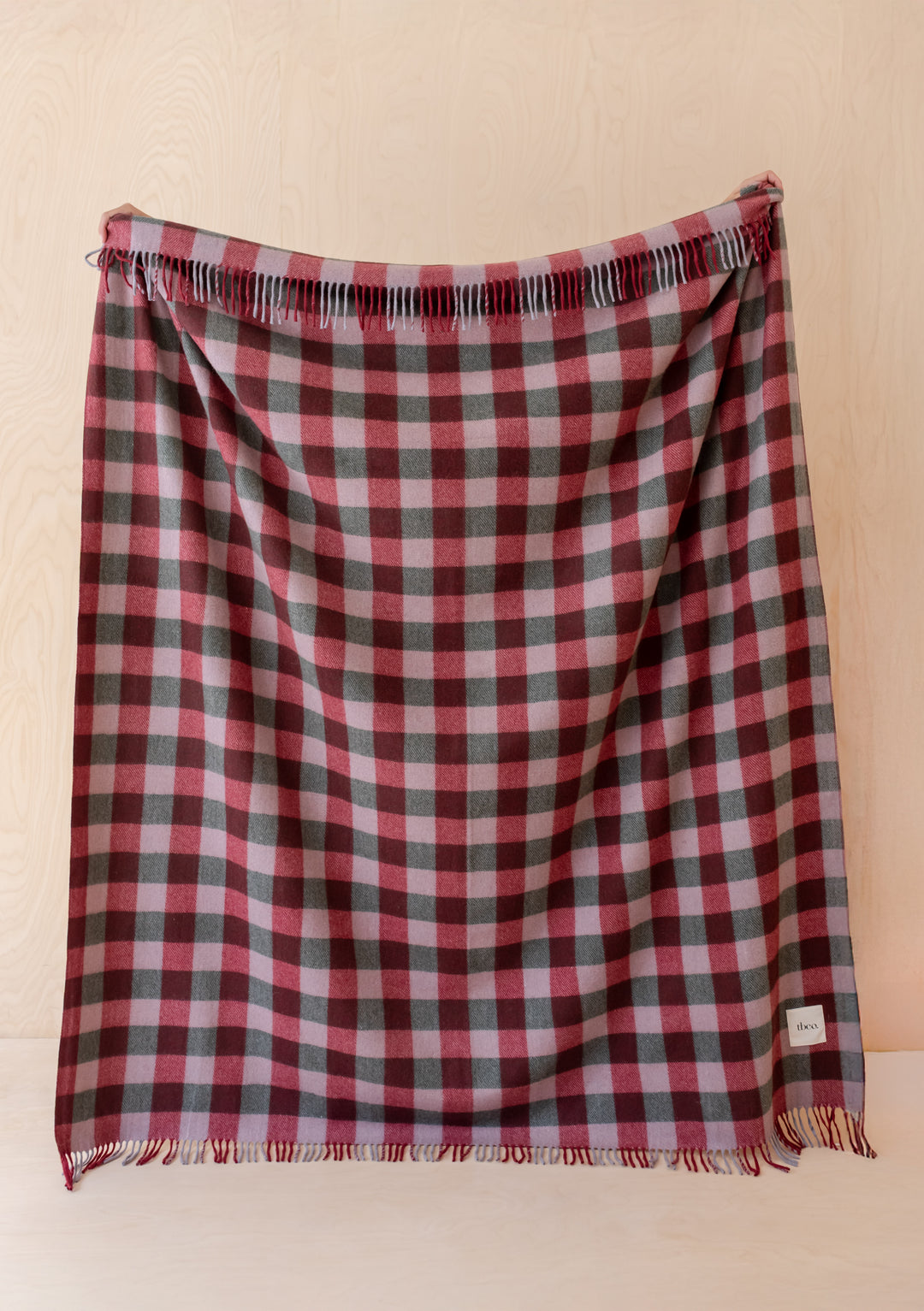 Recycled Wool Blanket in Wine Gingham by TBCo showcasing burgundy and lilac gingham with soft fringed edges.