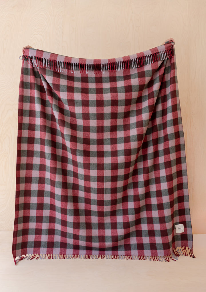 Recycled Wool Blanket in Wine Gingham by TBCo showcasing burgundy and lilac gingham with soft fringed edges.