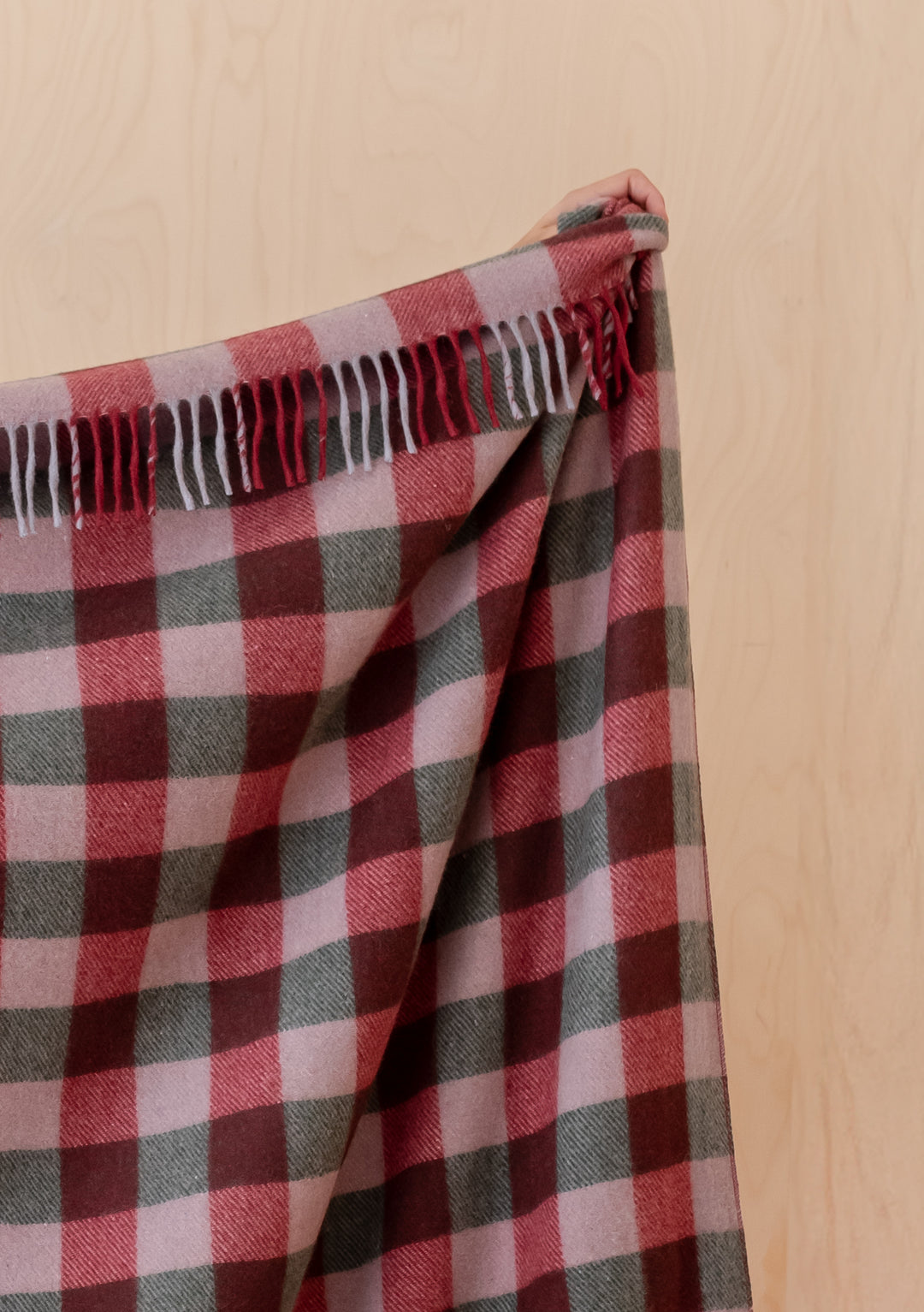 Recycled Wool Blanket in Wine Gingham by TBCo showing fringed edge and soft checked pattern in warm colours