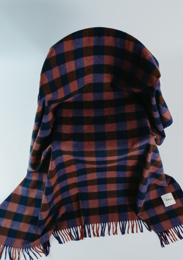 Recycled Wool Blanket in Midnight Gingham by TBCo with navy and brown checks and fringed edges for cosy comfort