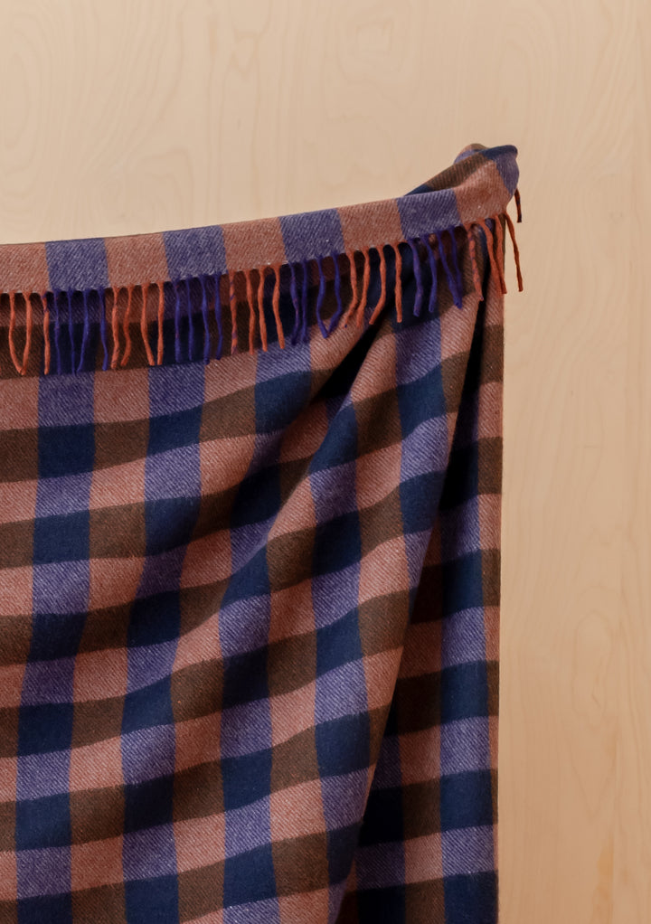TBCo Recycled Wool Blanket in Midnight Gingham draped with fringed edges showcasing soft recycled fibres and cosy warmth