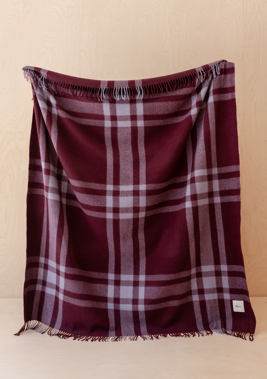 TBCo Recycled Wool Blanket in Burgundy Modern Tartan with fringed edges, crafted from recycled wool and mixed fibres.