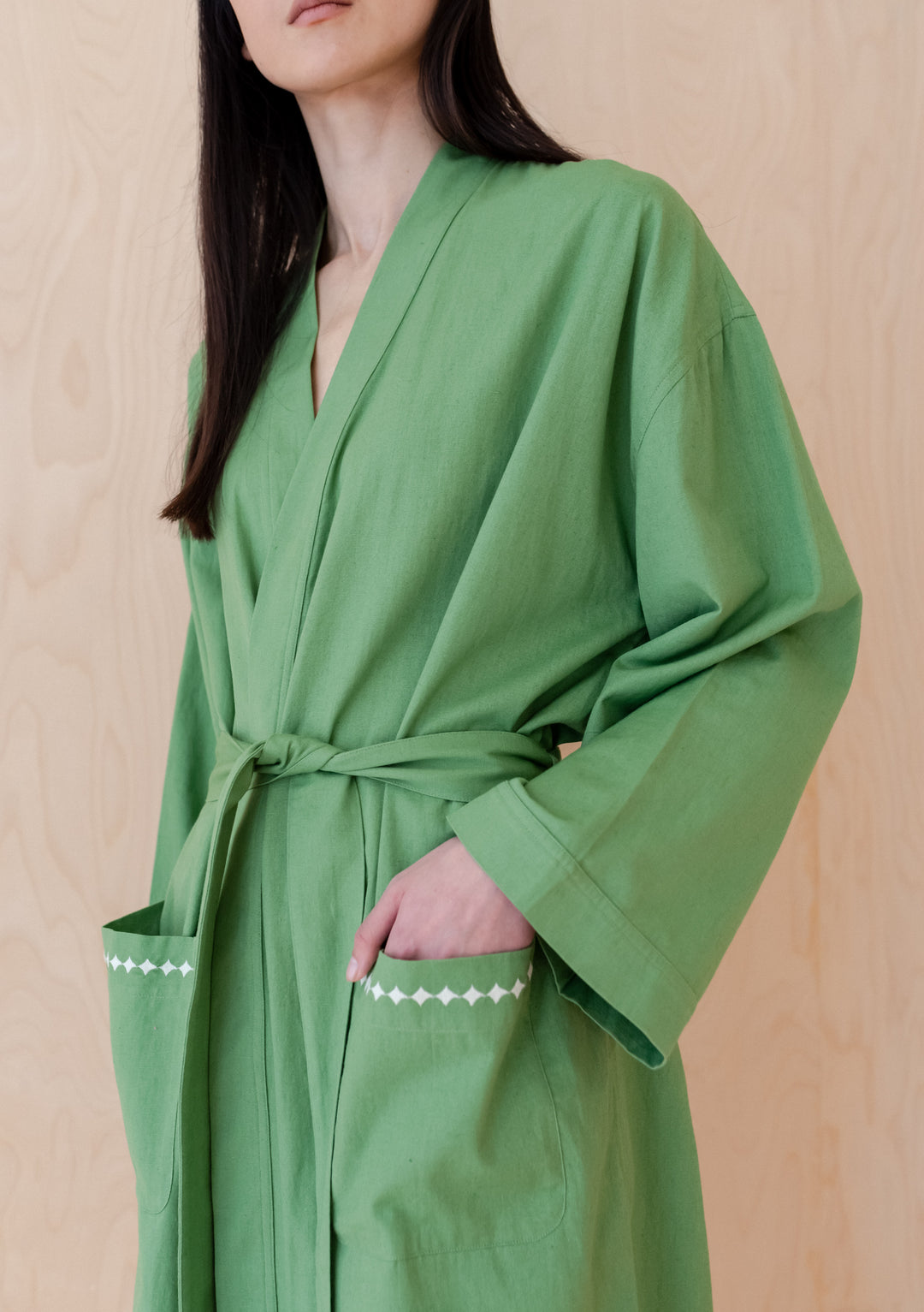 Elegant TBCo Cotton & Linen Robe in green with embroidered pockets, featuring wide sleeves and a sewn-in belt, perfect for lounging