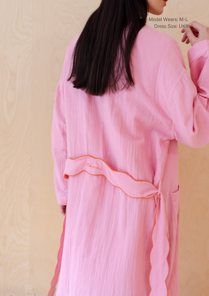 Soft pink cotton robe by TBCo featuring delicate scalloped edges and relaxed fit, showcasing elegant loungewear design