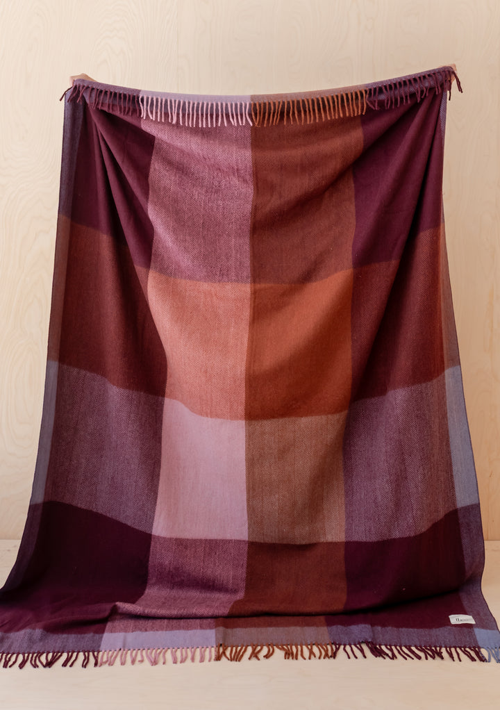 TBCo Recycled Wool Extra Large Blanket in Berry Frame Check with fringed edges in warm berry and burgundy tones