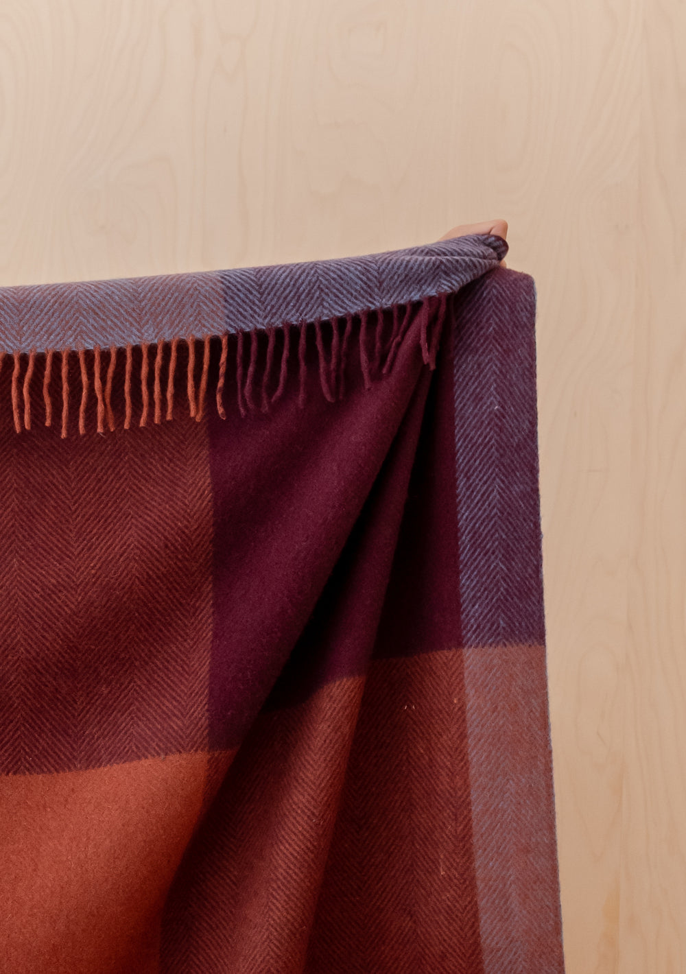 TBCo Recycled Wool Extra Large Blanket in Berry Frame Check with fringed edges in warm berry and burgundy tones