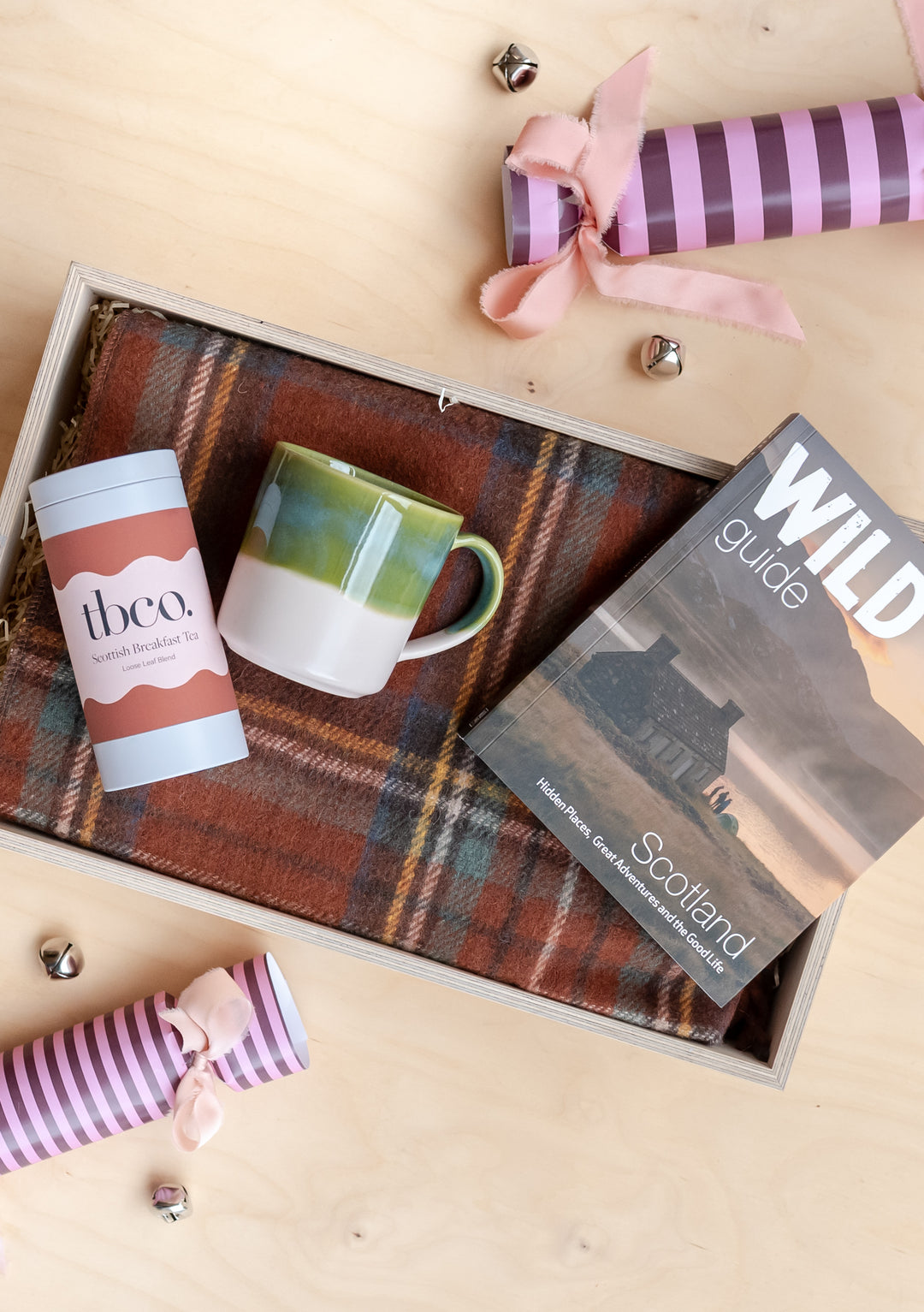 Ready-Made Scottish Treats Gift Box by TBCo with tartan blanket, Scottish breakfast tea, green dip mug, and Wild Guide Scotland book