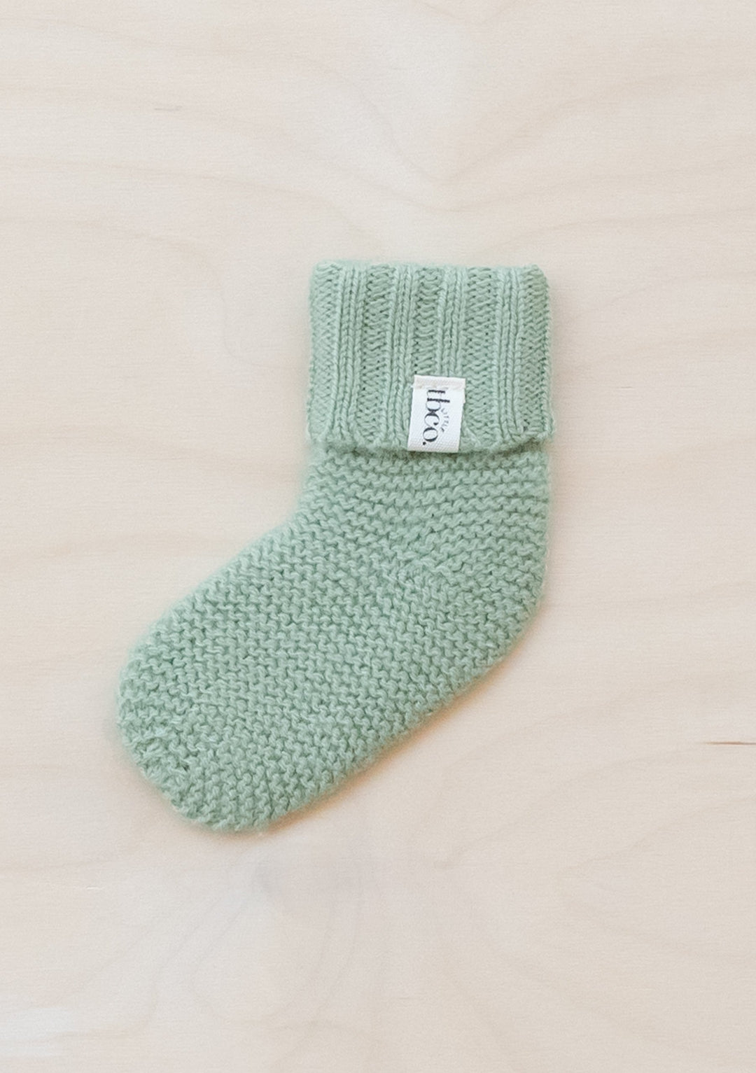 TBCo Merino Wool Baby Socks in Pistachio colour, knitted with ribbed cuff and textured stitch pattern for infants