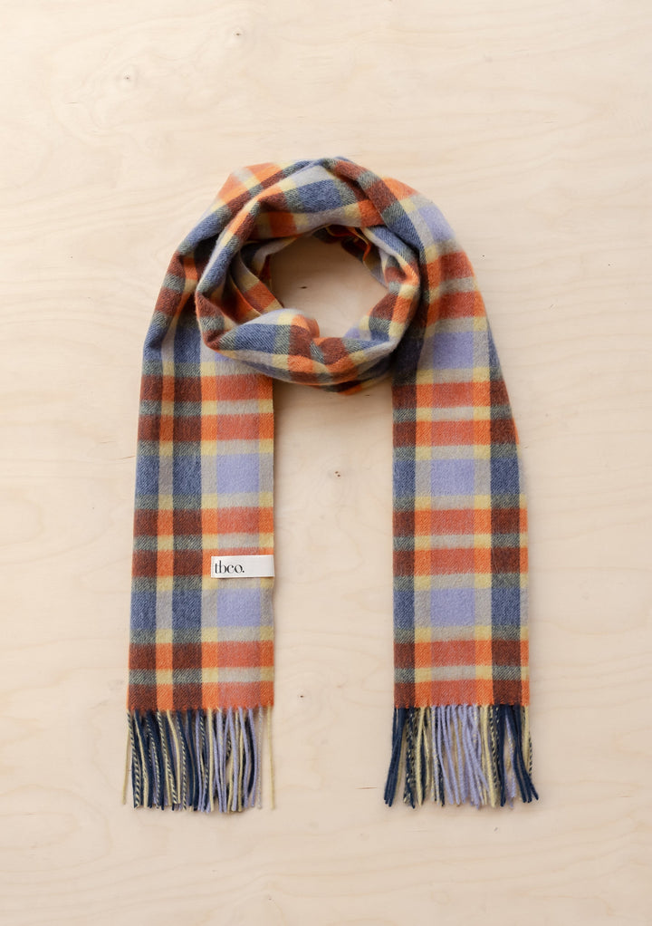 TBCo Lambswool Oversized Scarf in Lilac Multi Check laid flat showing lilac, indigo, orange plaid pattern with fringed ends