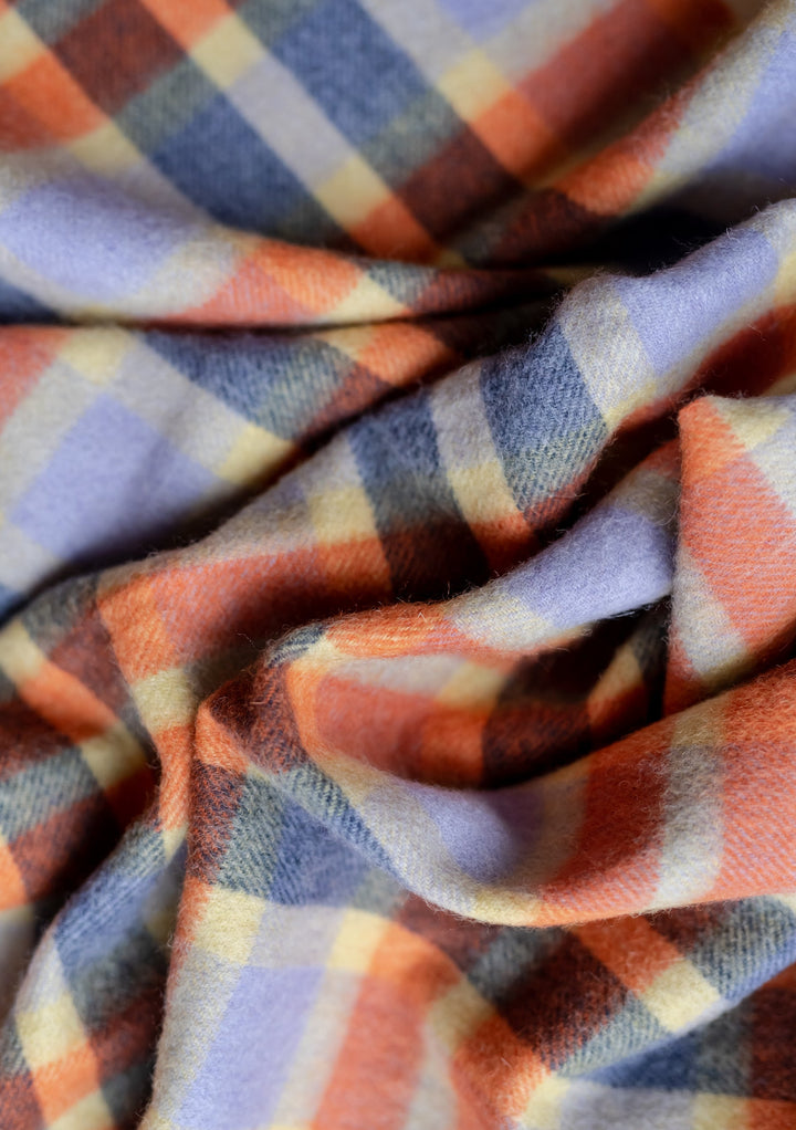 TBCo Lambswool Oversized Scarf in Lilac Multi Check featuring soft folds of plaid pattern in lilac, indigo, orange and cream colours