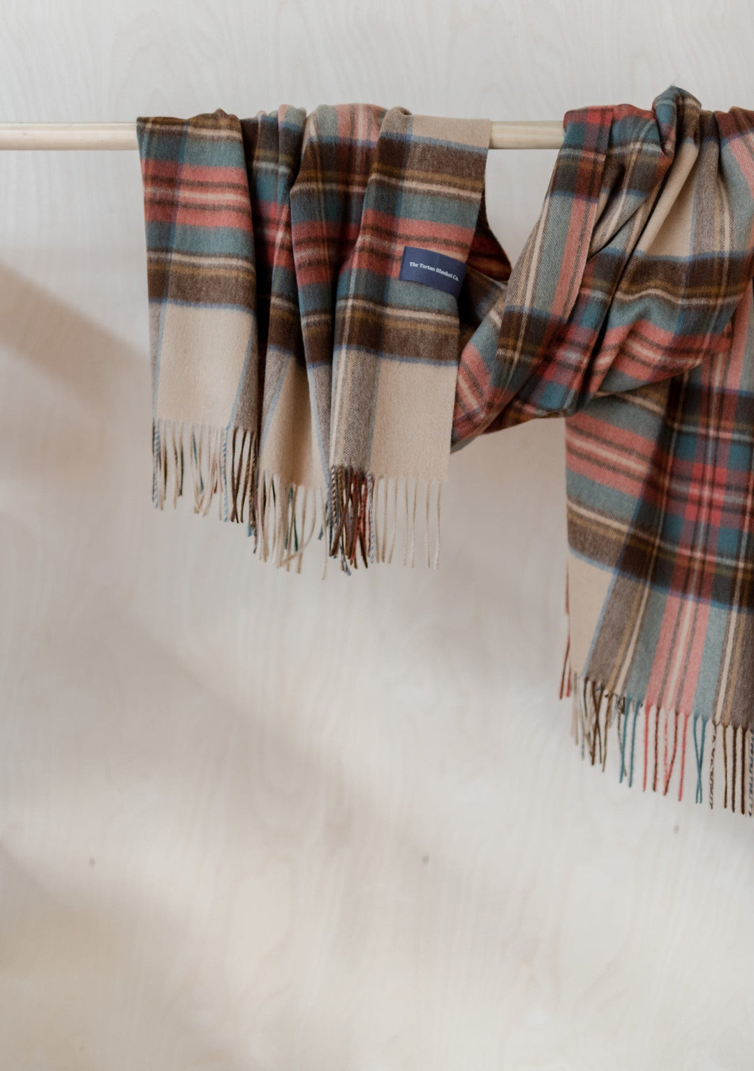TBCo Stewart Dress Antique Tartan Lambswool Blanket Scarf draped elegantly showing plaid pattern and fringed edges in camel and red