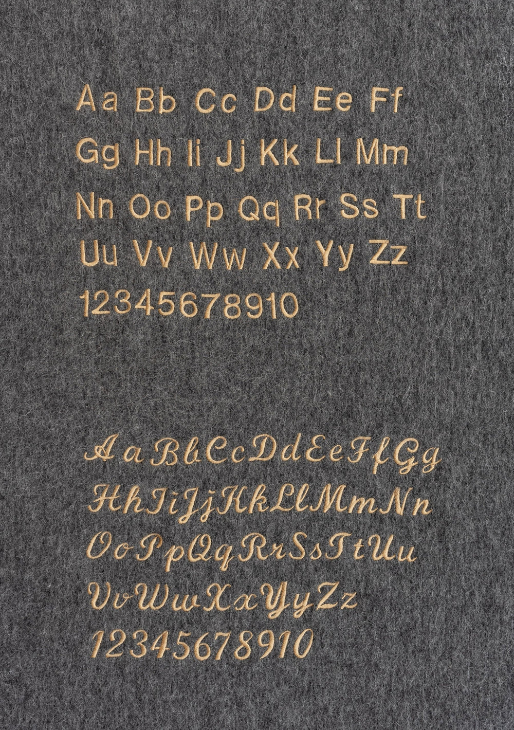 Custom embroidery options displayed on dark fabric for TBCo Merino Wool Triangle Scarf in Sourdough