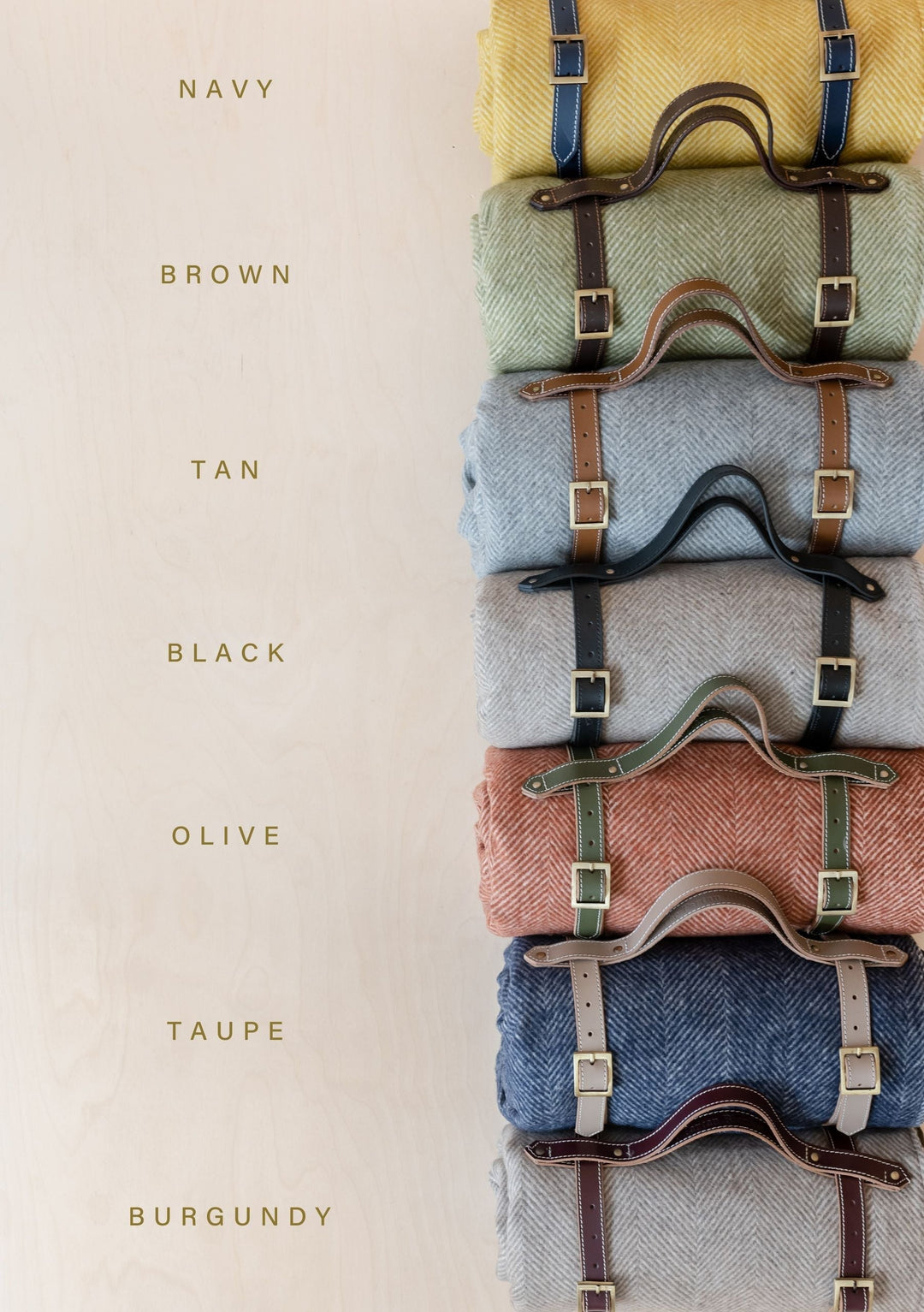 TBCo Leather Picnic Carrier in multiple colours, featuring a premium leather strap with brass buckles, designed for securely carrying rolled-up picnic blankets. A stylish and functional accessory for outdoor adventures, perfect for easy transportation of TBCo wool picnic blankets.