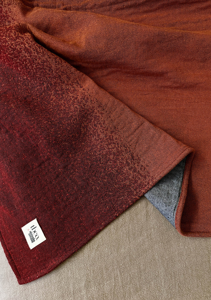 TBCo x Abisola Omole Hues Cotton Throw featuring gradient design in rich burgundy and charcoal tones, displaying luxurious texture