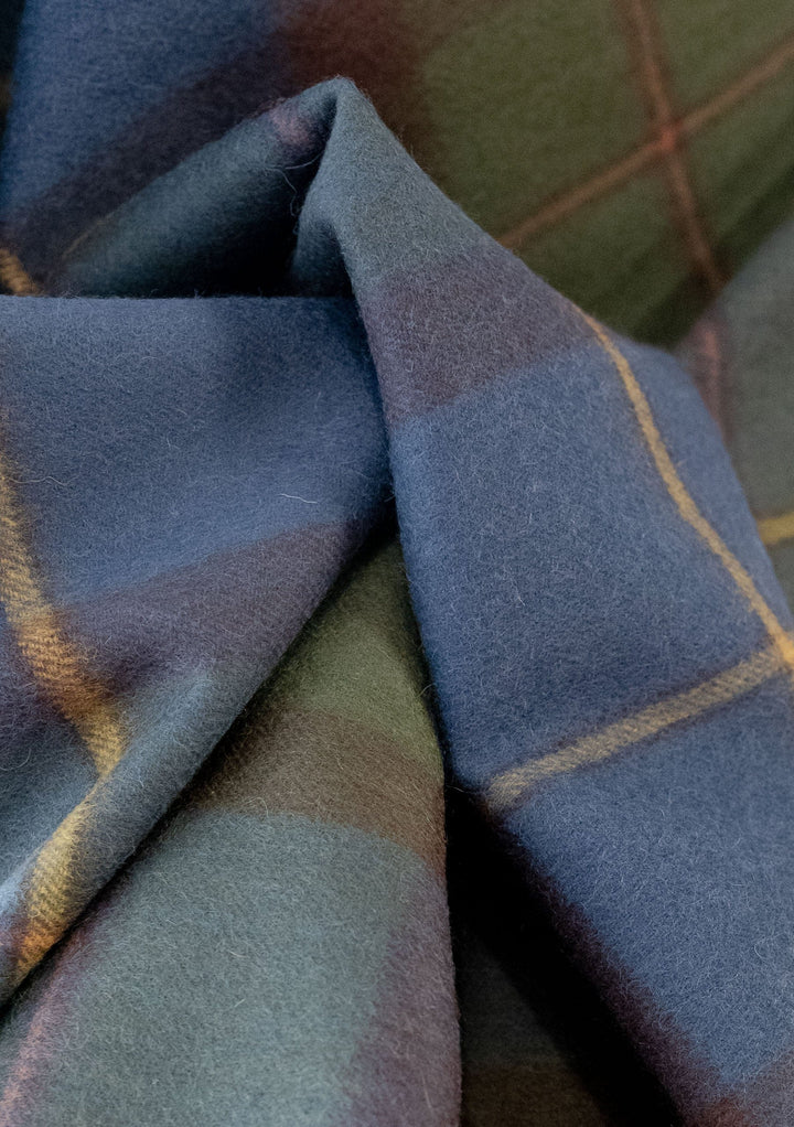 TBCo Lambswool Oversized Scarf in Macleod of Harris Antique Tartan, featuring soft folds of navy and green plaid pattern
