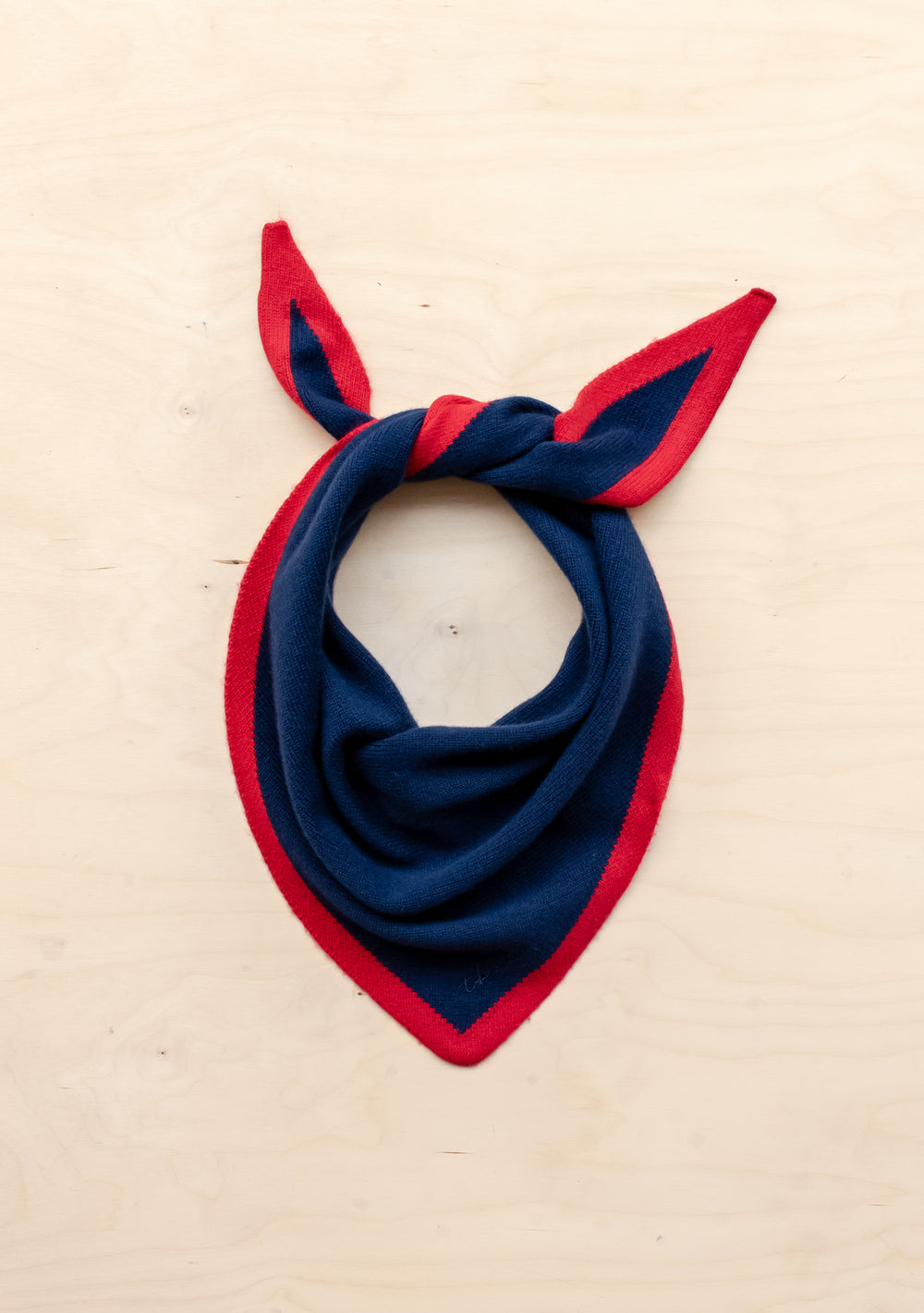 Merino Triangle Scarf in Navy & Red by TBCo, knitted merino wool with contrasting red edge and embroidered logo detail.