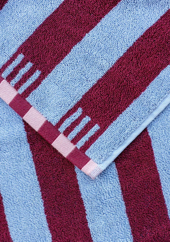 TBCo Cotton Towels in Blue Stripe with burgundy stripes and pink checkered trim detail, showcasing luxurious Turkish cotton texture