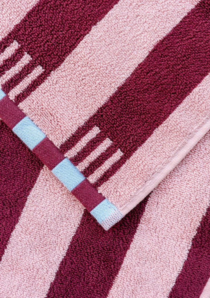 TBCo Cotton Towels in Pink Stripe with burgundy stripes and blue checkerboard trim, close-up of luxurious textured pattern