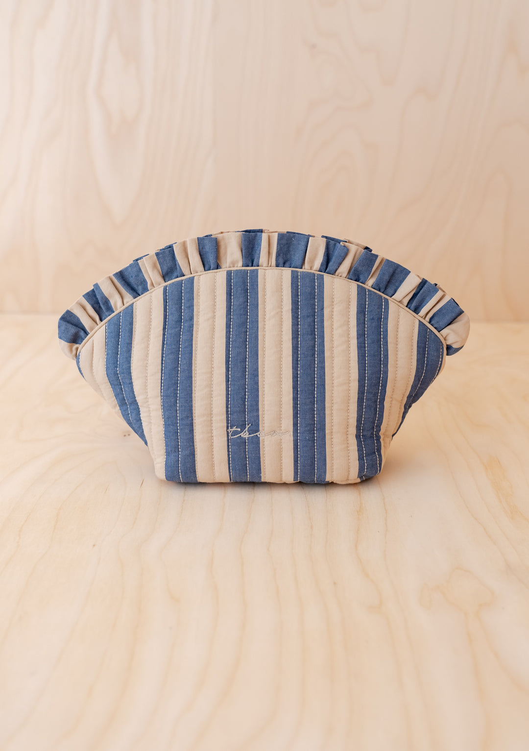 Curved TBCo Cotton Wash Bag in Navy Stripe with ruffled top, crescent shape, lightweight and structured design