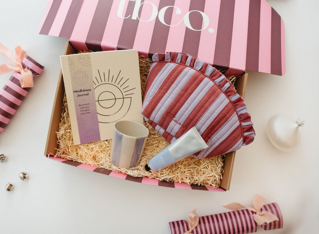 A ready-made TBCo gift box with lambswool blanket, mug, socks, candle and notebook.
