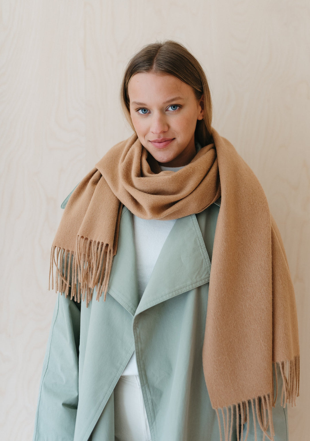 TBCo Lambswool Oversized Scarf in Camel styled with mint green coat, showcasing fringed ends and luxurious draping