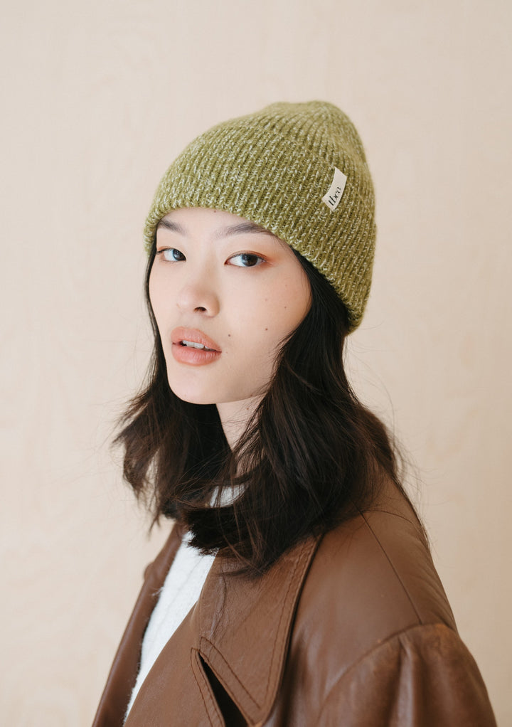 Chunky knit TBCo Cashmere & Merino Beanie in Olive Fleck shown in lifestyle setting, displaying textured flecked pattern