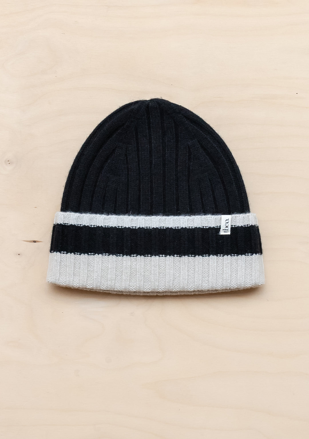 TBCo Cashmere & Merino Beanie in Black & Cream with ribbed texture and contrasting cream stripe on black wool winter hat