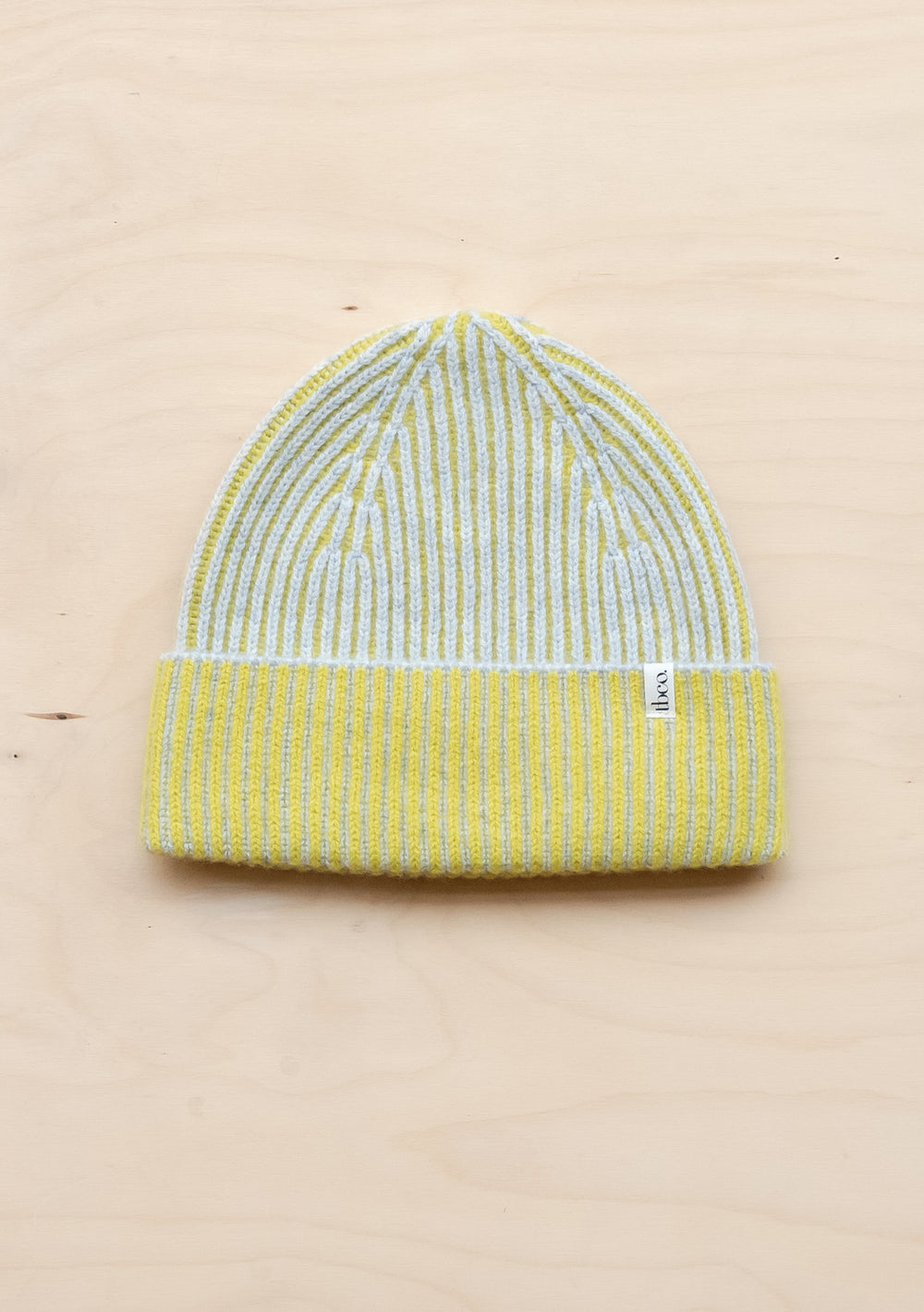 TBCo lime and grey striped cashmere merino beanie displayed flat, showing ribbed texture and folded brim