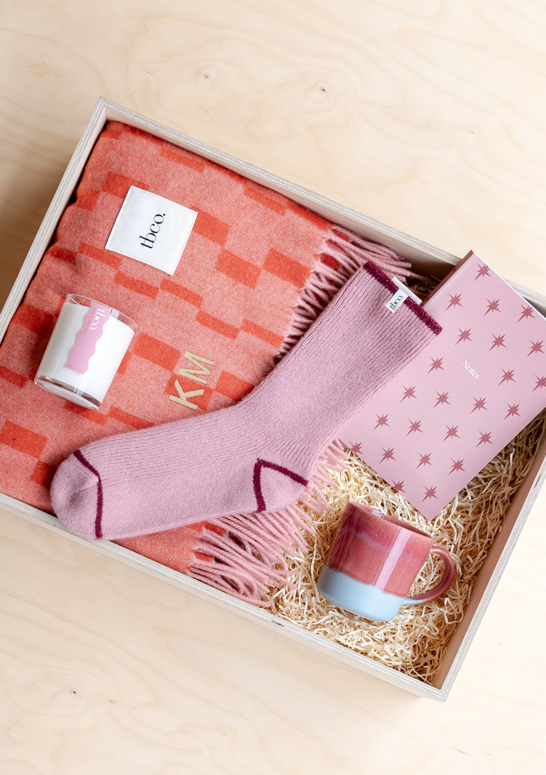 Build Your Own Mothers Day Gift Box from TBCo featuring a cosy pink blanket, matching socks and candles in a customisable gift set