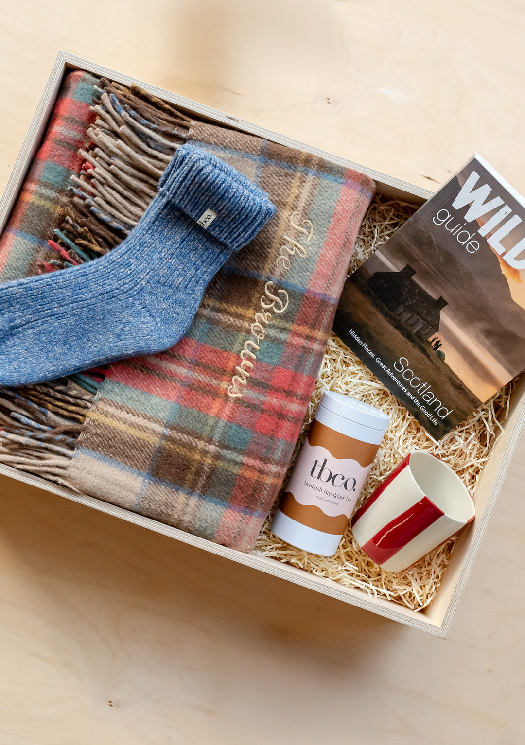 TBCo Build Your Own Tartan Gift Box featuring cozy wool blanket, blue socks, coffee cup and guide in wooden presentation box