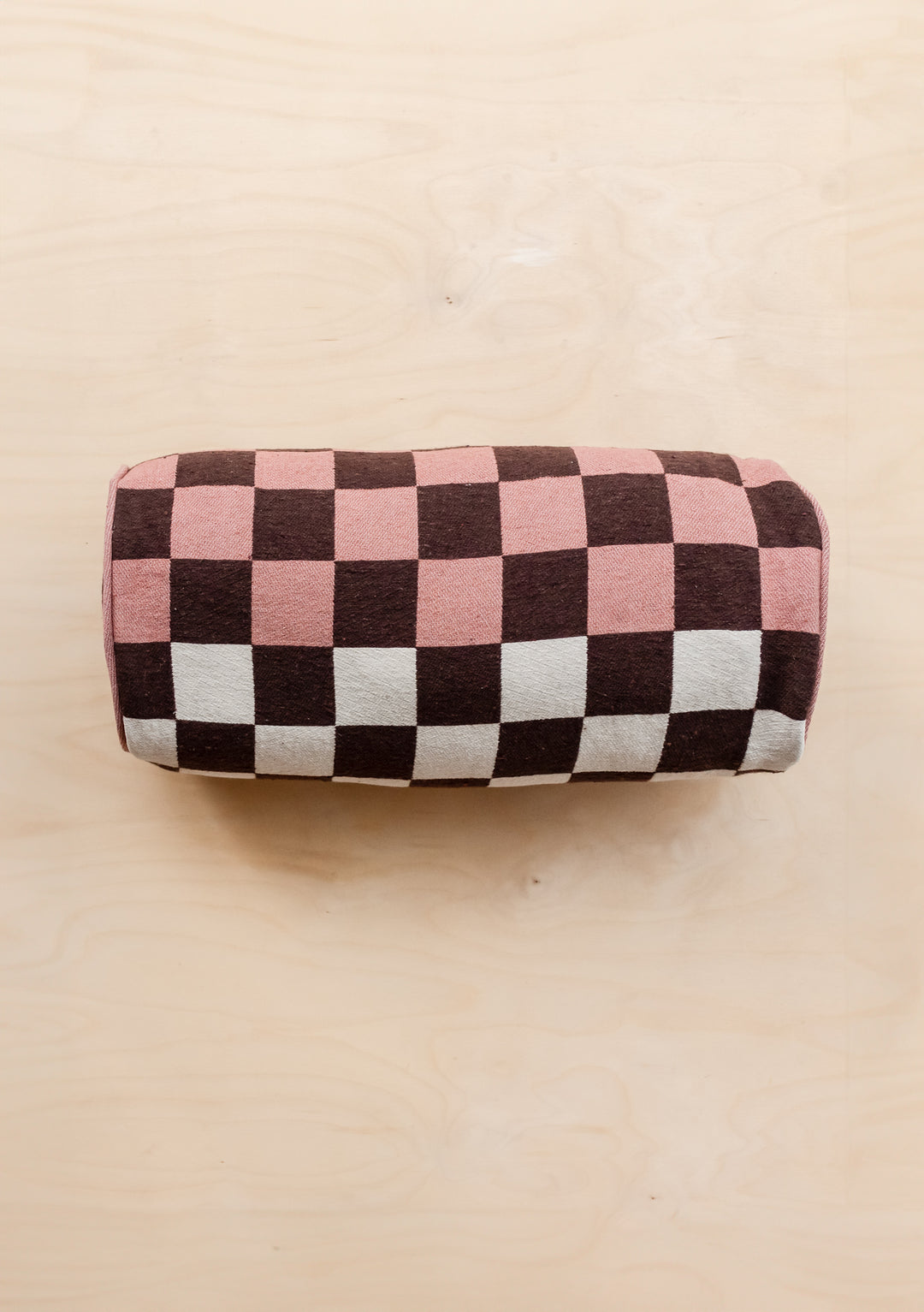 TBCo Cotton Cushion Cover in reversible bolster design with pink, brown and cream checkerboard pattern on neutral background