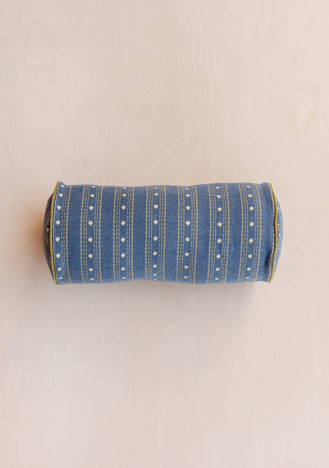 TBCo Cotton Bolster Cushion Cover in navy blue with delicate ditsy floral pattern and white dotted stripes, cylindrical shape