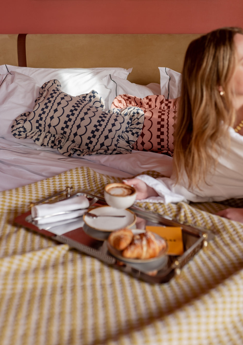 TBCo Cotton Cushion Cover in Navy Ruffle displayed on bed with breakfast tray featuring coffee and croissant