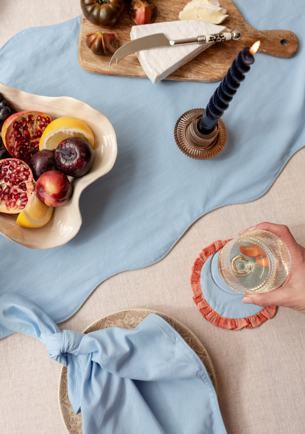 Table setting with TBCo Blue Apricot Cotton Coaster and placemat. Sustainable and elegant additions to any table setting, designed for both protection and aesthetic appeal