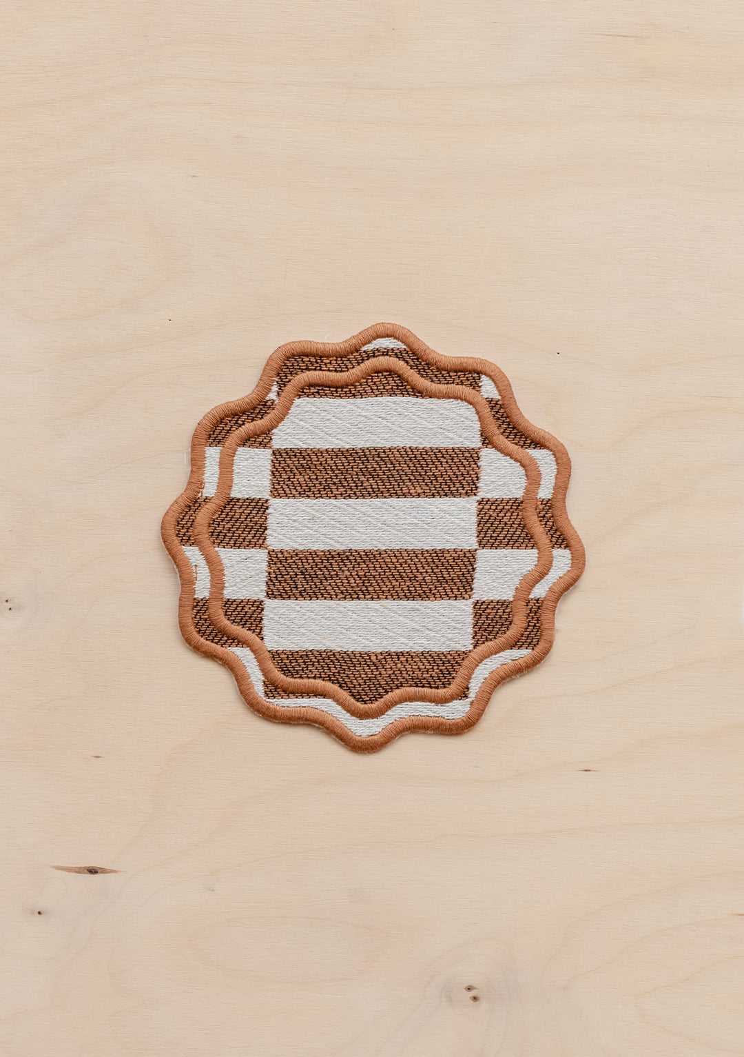 TBCo cotton coasters in camel checkerboard featuring a soft woven texture design . Designed for stylish and practical table protection, these eco-friendly coasters add warmth and sophistication to any home decor.