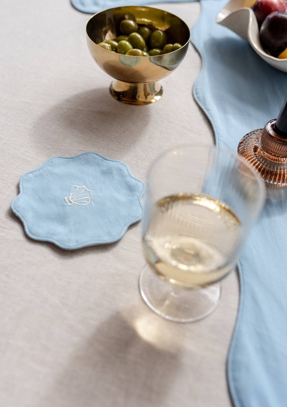 Table setting with TBCo Blue Cotton and Linen Coaster and placemats. Sustainable and elegant additions to any table setting, designed for both protection and aesthetic appeal