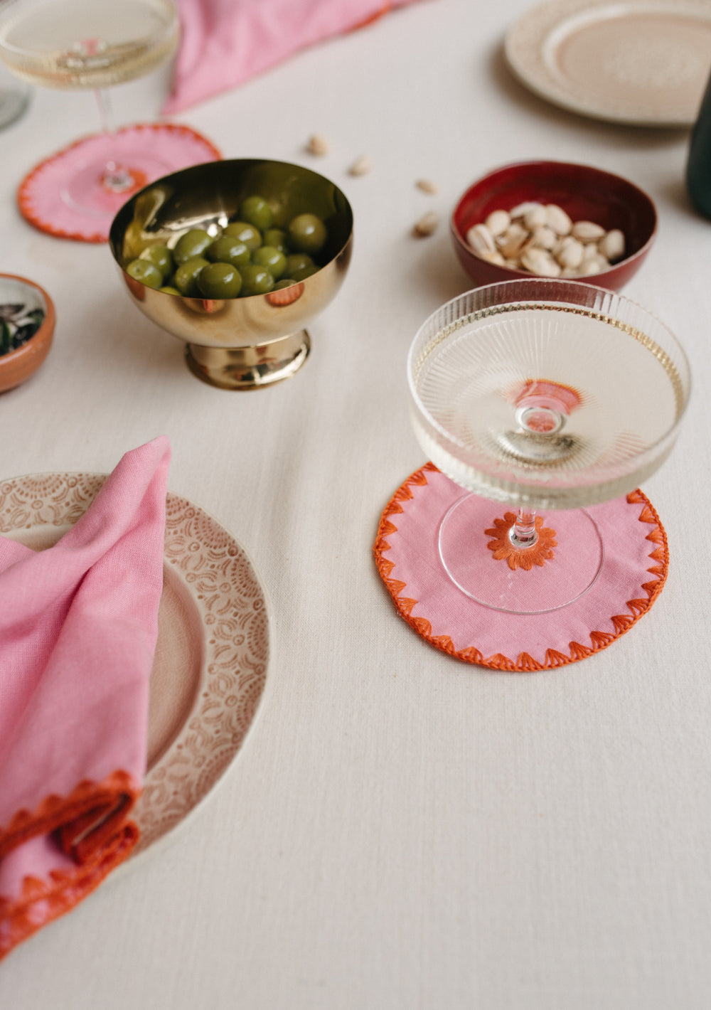 Table setting with TBCo Pink Cotton Coaster and placemats. Sustainable and elegant additions to any table setting, designed for both protection and aesthetic appeal