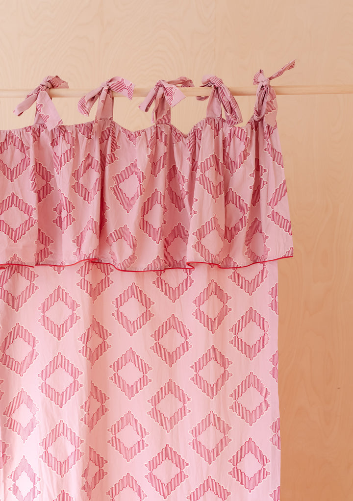 Portrait image of TBCo Pair of Cotton Tie-Top Curtains in Pink Diamond with bow ties in gallery position one