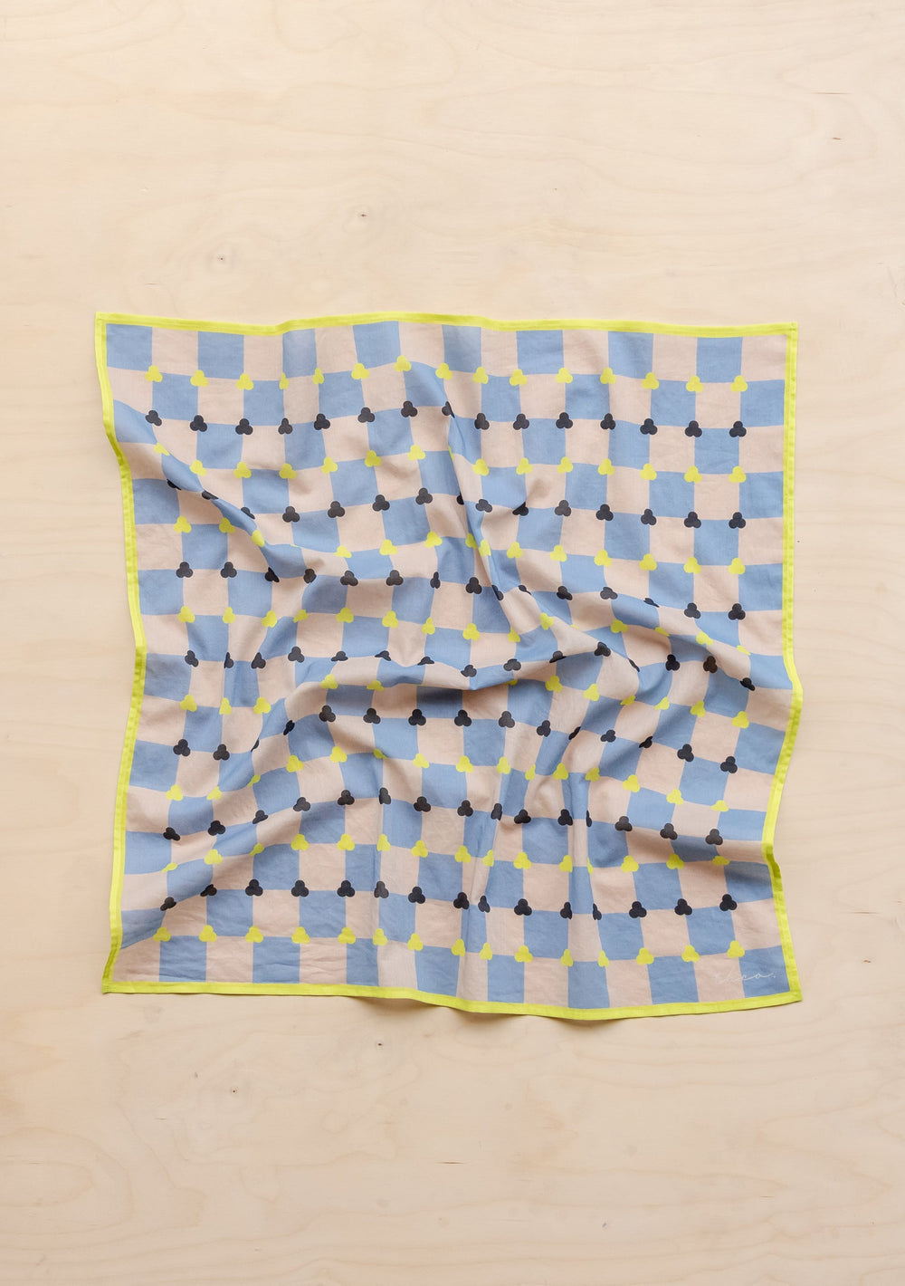 TBCo Cotton Square Scarf in blue and cream checkerboard pattern with yellow trim, displayed flat on beige surface