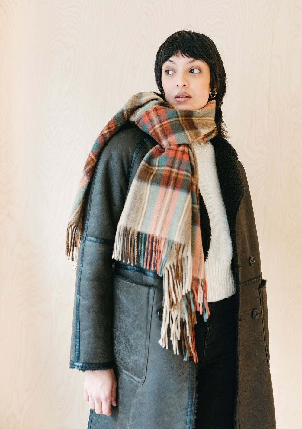 Luxurious TBCo Stewart Dress Antique Tartan cashmere blanket scarf styled with winter coat showing plaid pattern and fringe detail