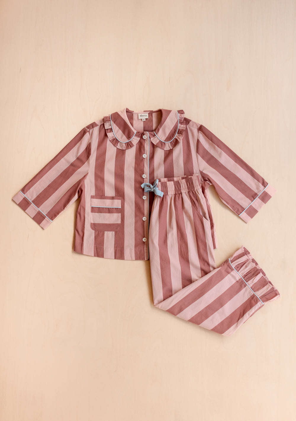 Striped cotton pyjamas from TBCo featuring pink and red stripes, ruffle collar and button-front design with elastic waist