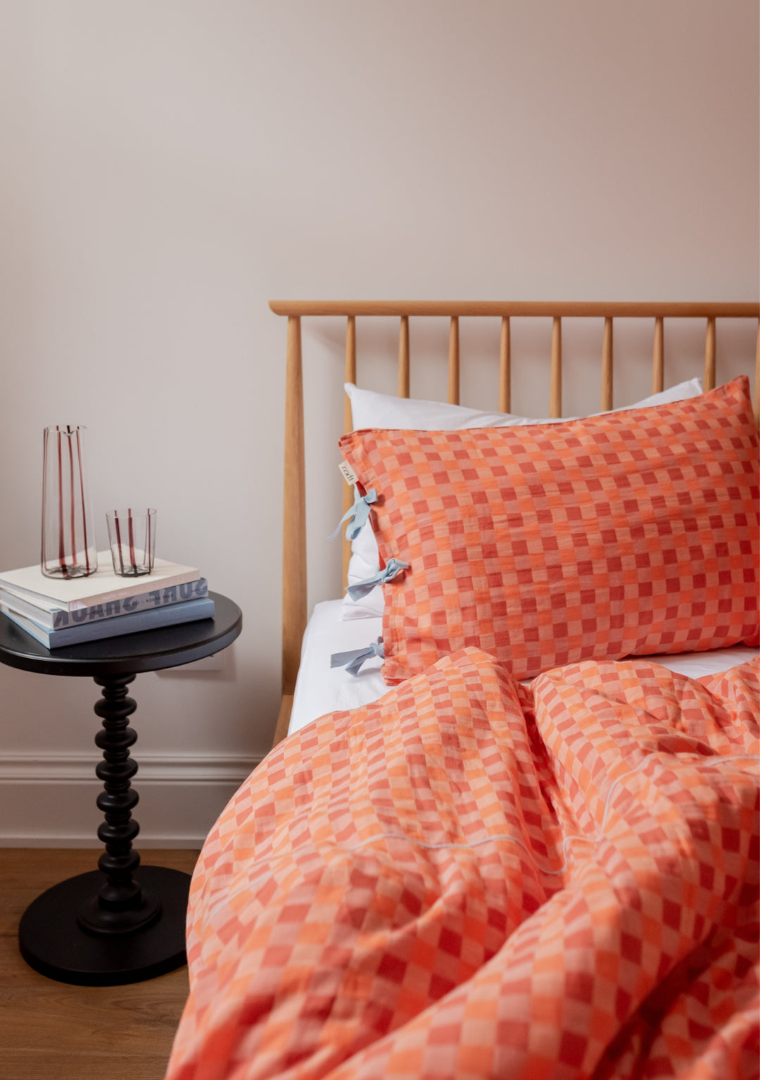 TBCo Cotton Duvet Cover in apricot checkerboard pattern displayed on wooden bed with blue ties and matching pillowcase