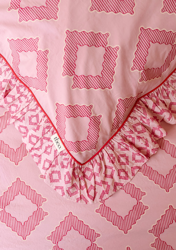 TBCo Cotton Duvet Cover & Pillowcases Set in Pink Diamond featuring layered pink geometric prints with ruffled edge detail