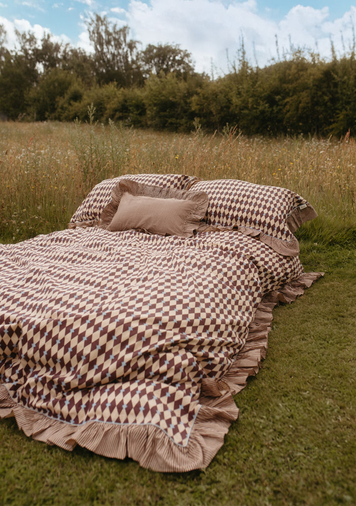Cotton Duvet Cover in Camel Harlequin by TBCo, featuring soft breathable cotton with ruffled edges and reversible pattern.
