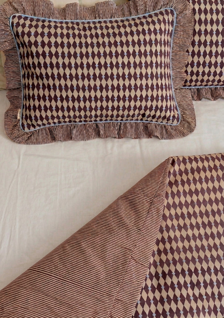 Close-up of TBCo Cotton Duvet Cover & Pillowcases Set in Camel Harlequin featuring diamond pattern and striped ruffled edges on soft cotton