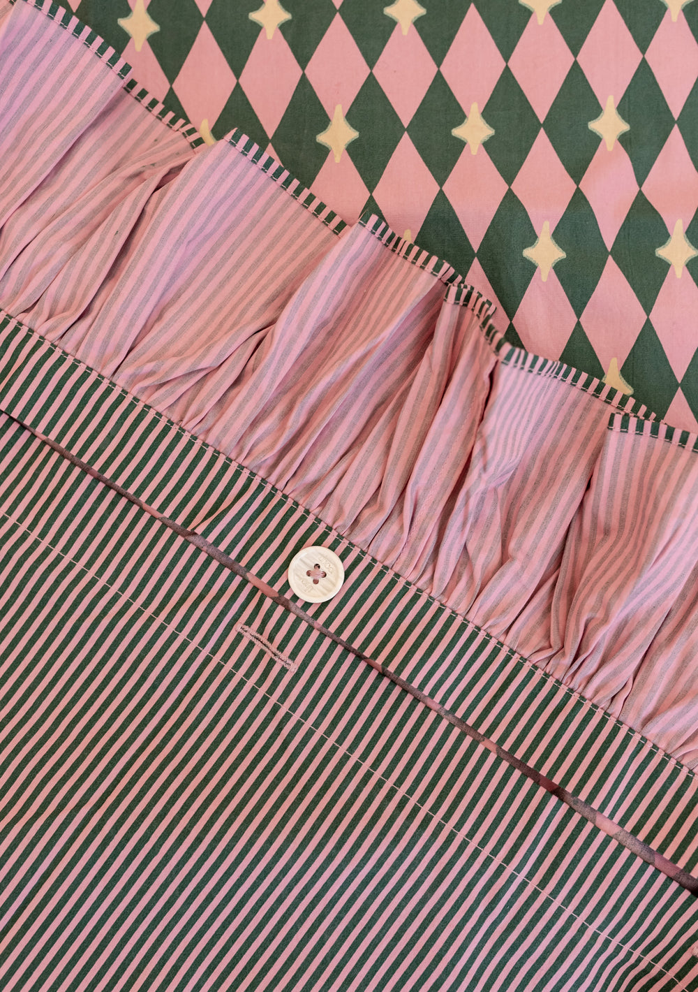 Cotton Duvet Cover in Pink Harlequin by TBCo with ruffled edge, reversible harlequin and stripe patterns, button closure.