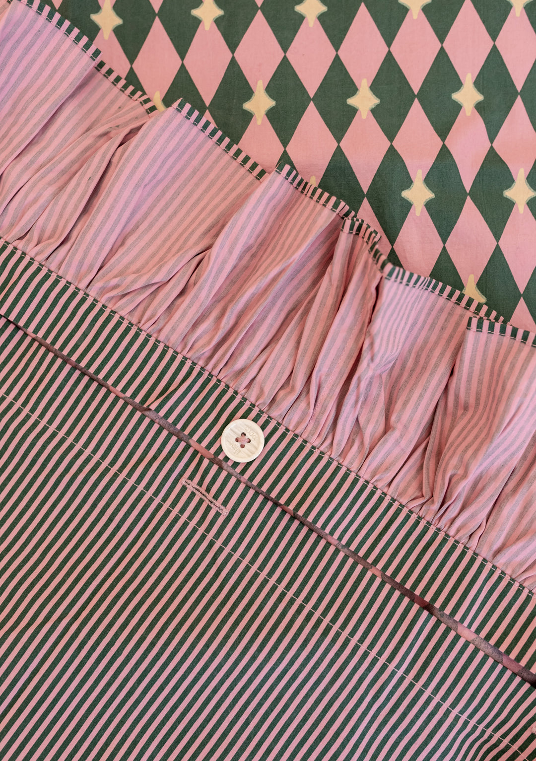 Cotton Duvet Cover in Pink Harlequin by TBCo with ruffled edge, reversible harlequin and stripe patterns, button closure.