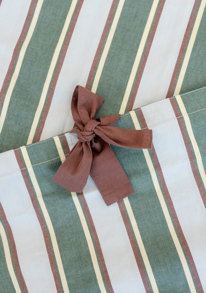 Cotton Duvet Cover in Blue Stripe by TBCo features soft, breathable cotton with delicate tie closures in blue and green stripes.