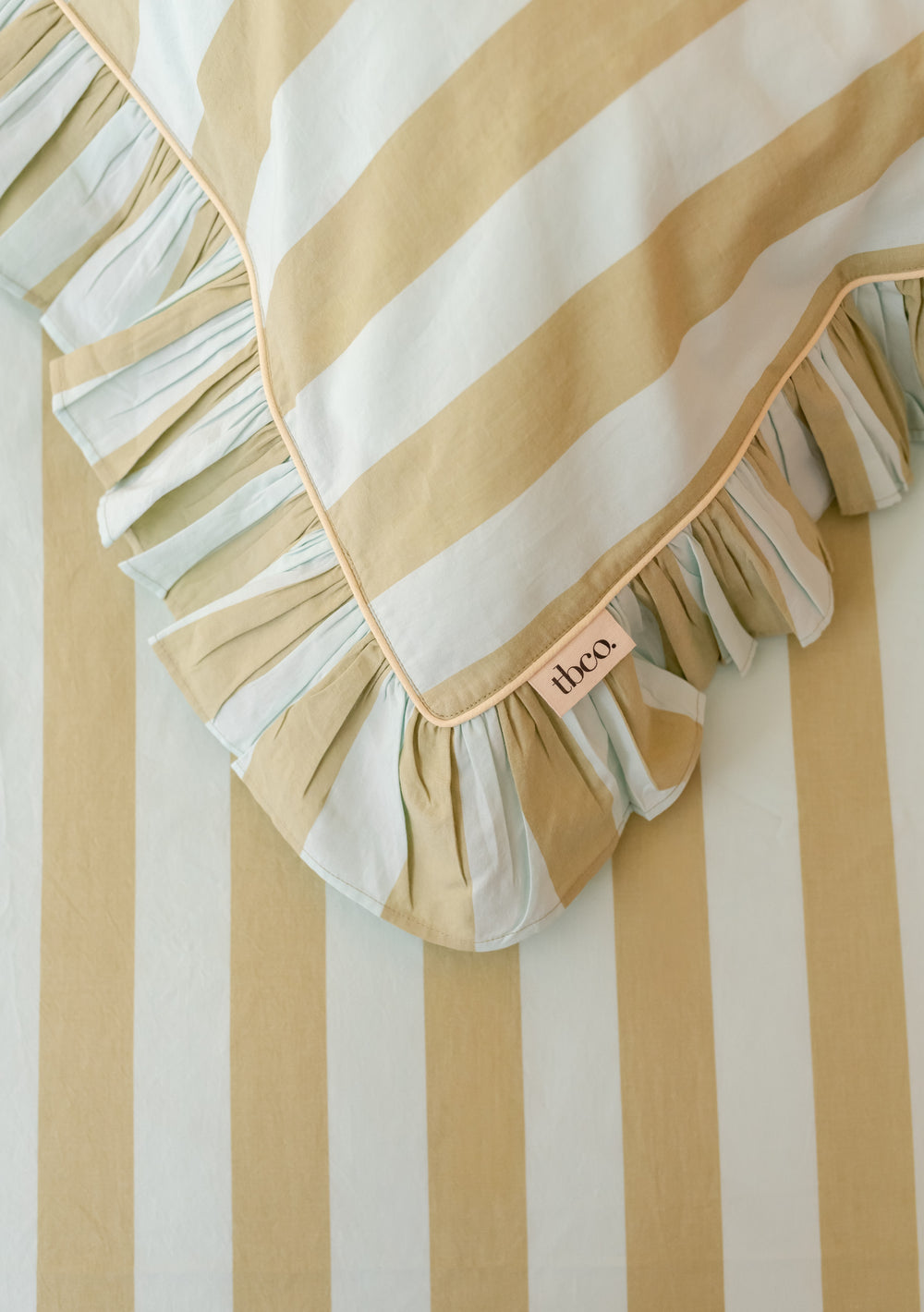 Pair of Cotton Pillowcases in Mint Stripe by TBCo showing ruffled edge and yellow piping in gallery position 2 portrait view