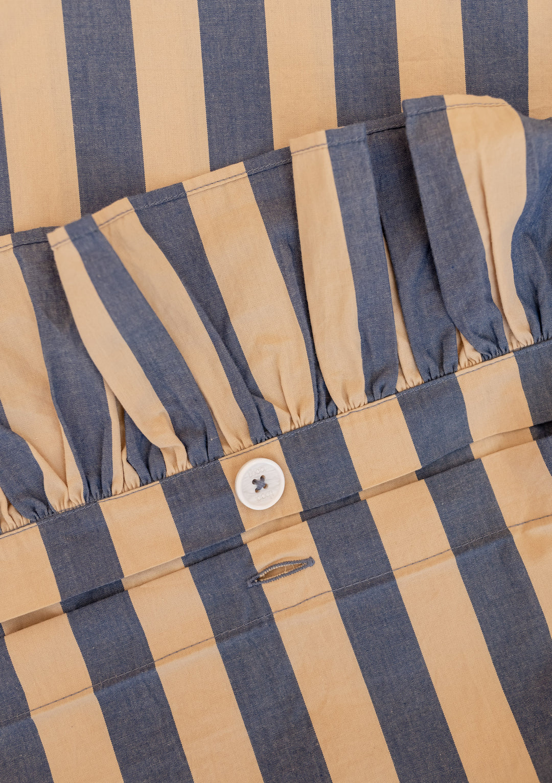 Close-up of TBCo Cotton Duvet Cover in Navy Stripe showing ruffled edge and concealed button closure.